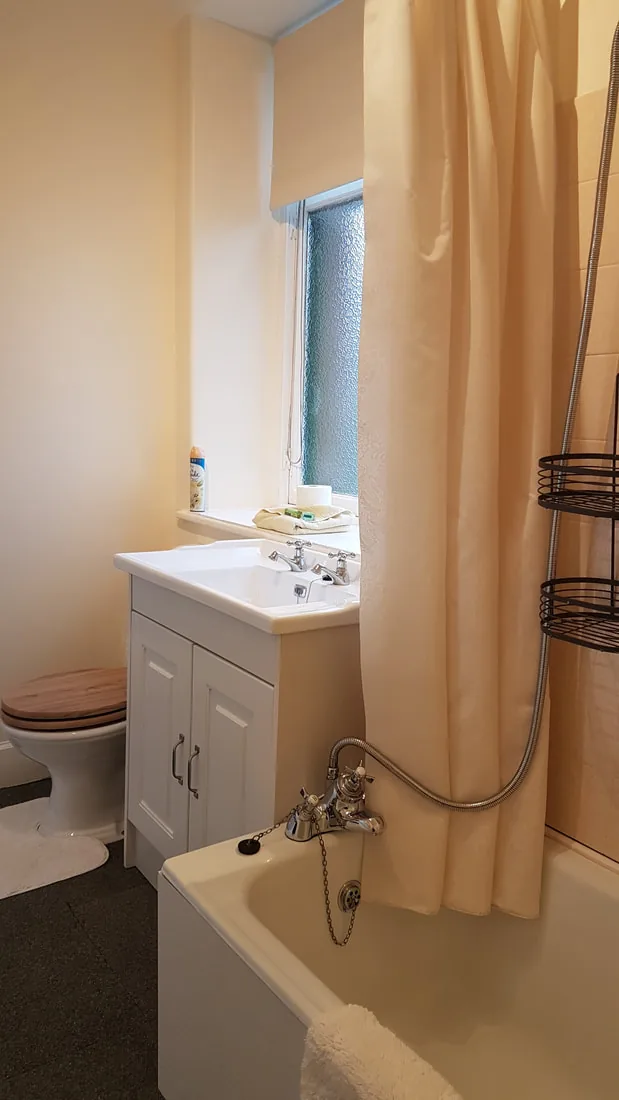 Bathroom in the Lawers Apartment with bath and shower over