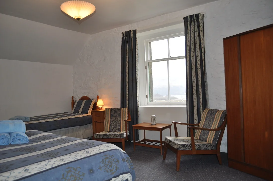 Family bedroom in the Lawers Apartment with king size and single bed